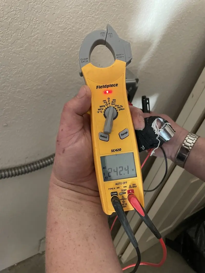 Voltage testing with clamp meter during Ceiling Fan Installation in University of California-Santa Barbara